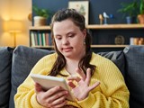 Young Woman With Disability Using Tablet