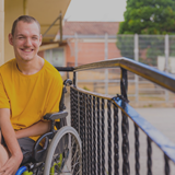 Disabled Person Dressed In Yellow In A Wheelchair
