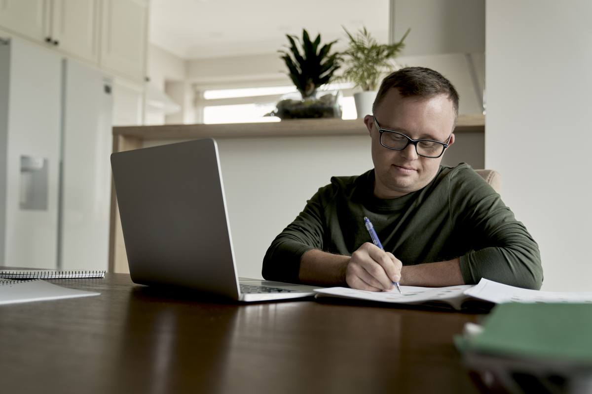 Man With Down Syndrome Learning At Home