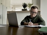 Man With Down Syndrome Learning At Home